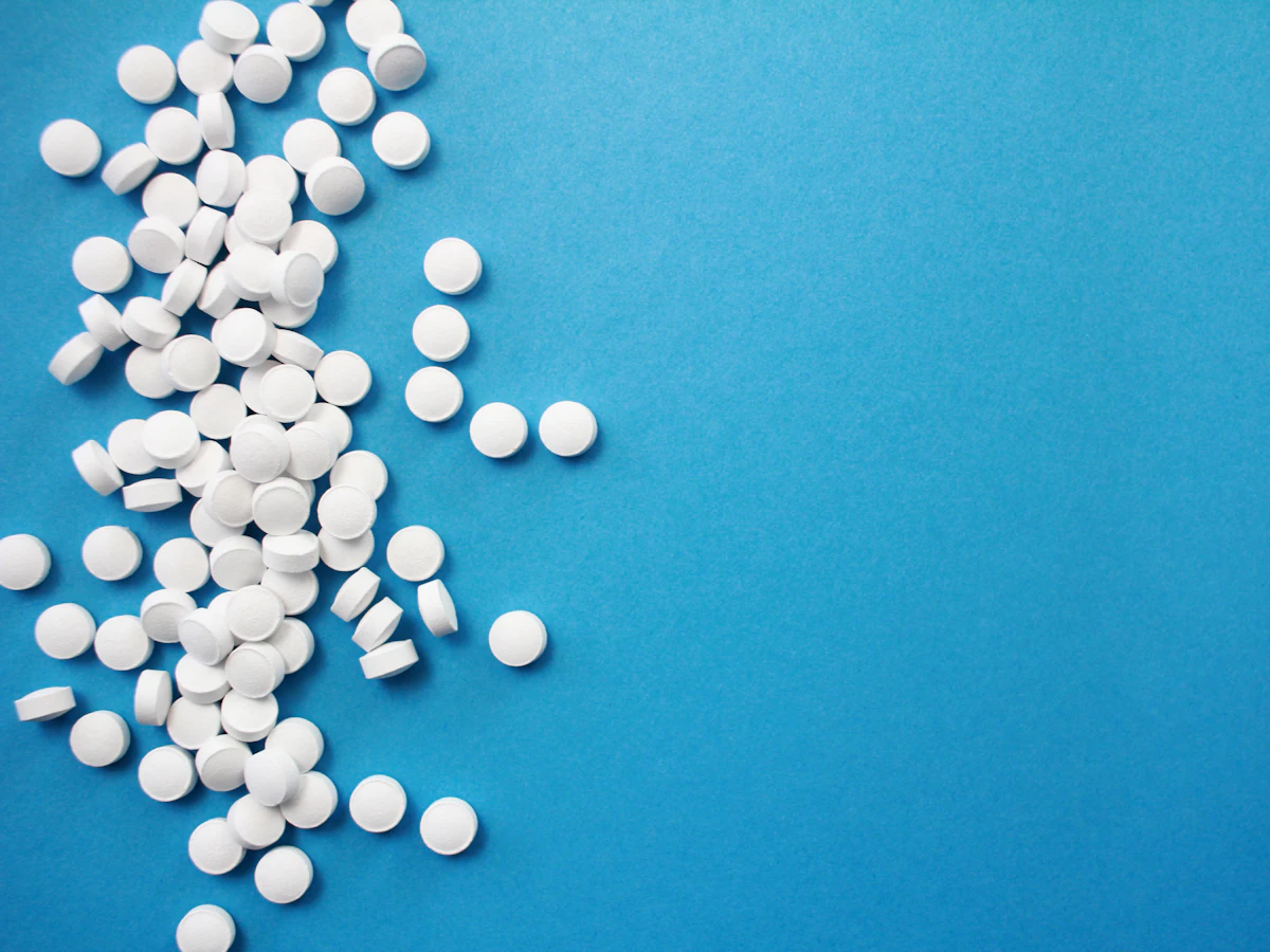 White tablets scattered across a blue surface