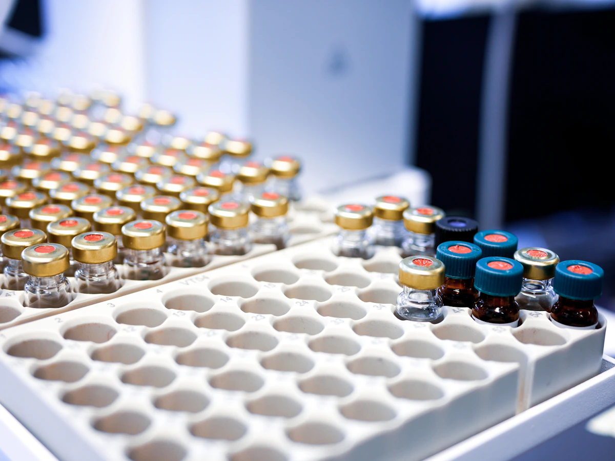 Rows of sealed sample vials in a white laboratory rack